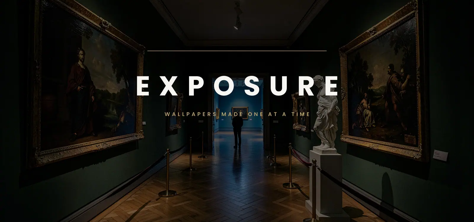 A gallery after closing, every painting in its own pool of warm light